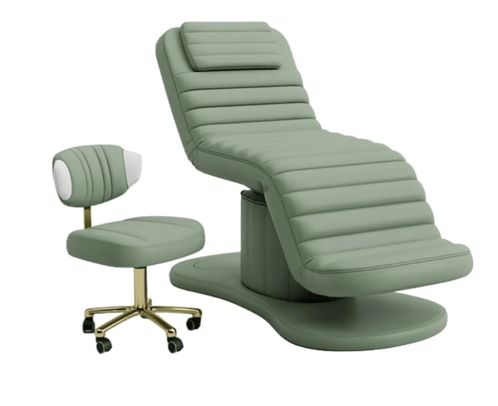 Sage green electric facial bed with matching esthetician stool featuring a gold rolling base
