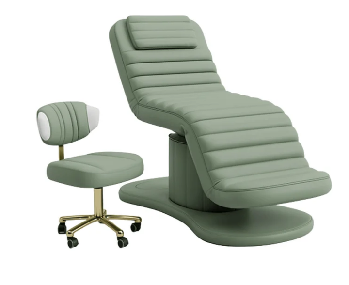 Sage green electric facial bed with matching esthetician stool featuring a gold rolling base