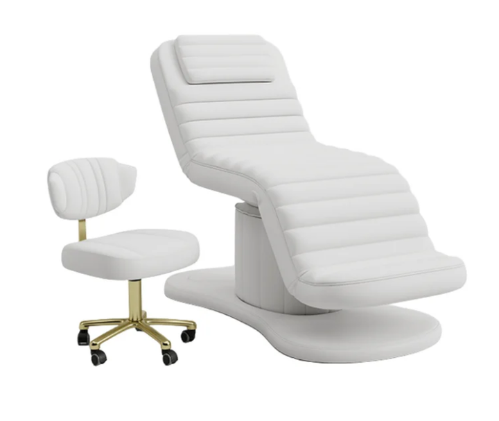 White electric facial bed with matching esthetician stool featuring a gold rolling base